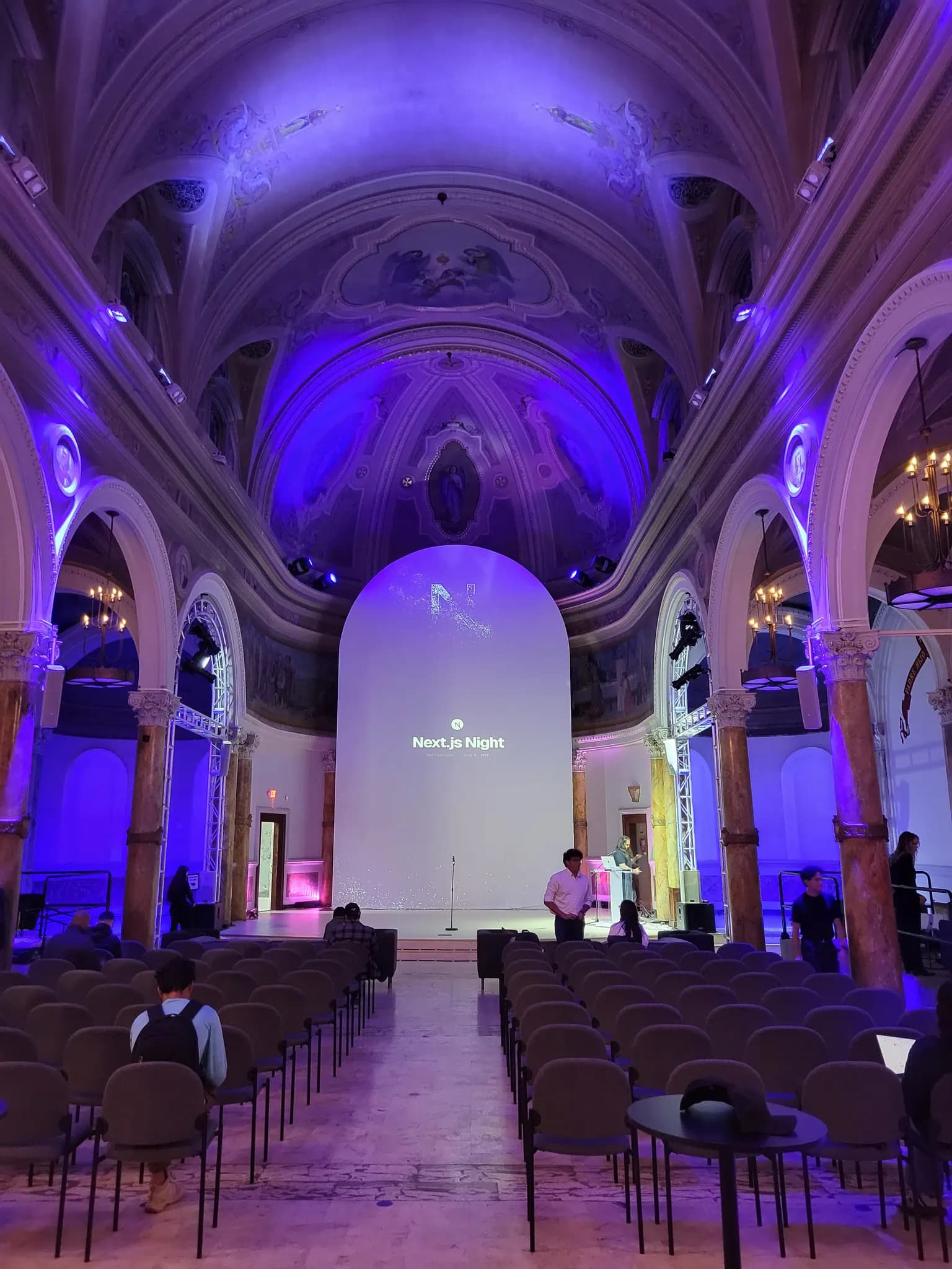 Next.js Night event stage in San Francisco with purple lighting