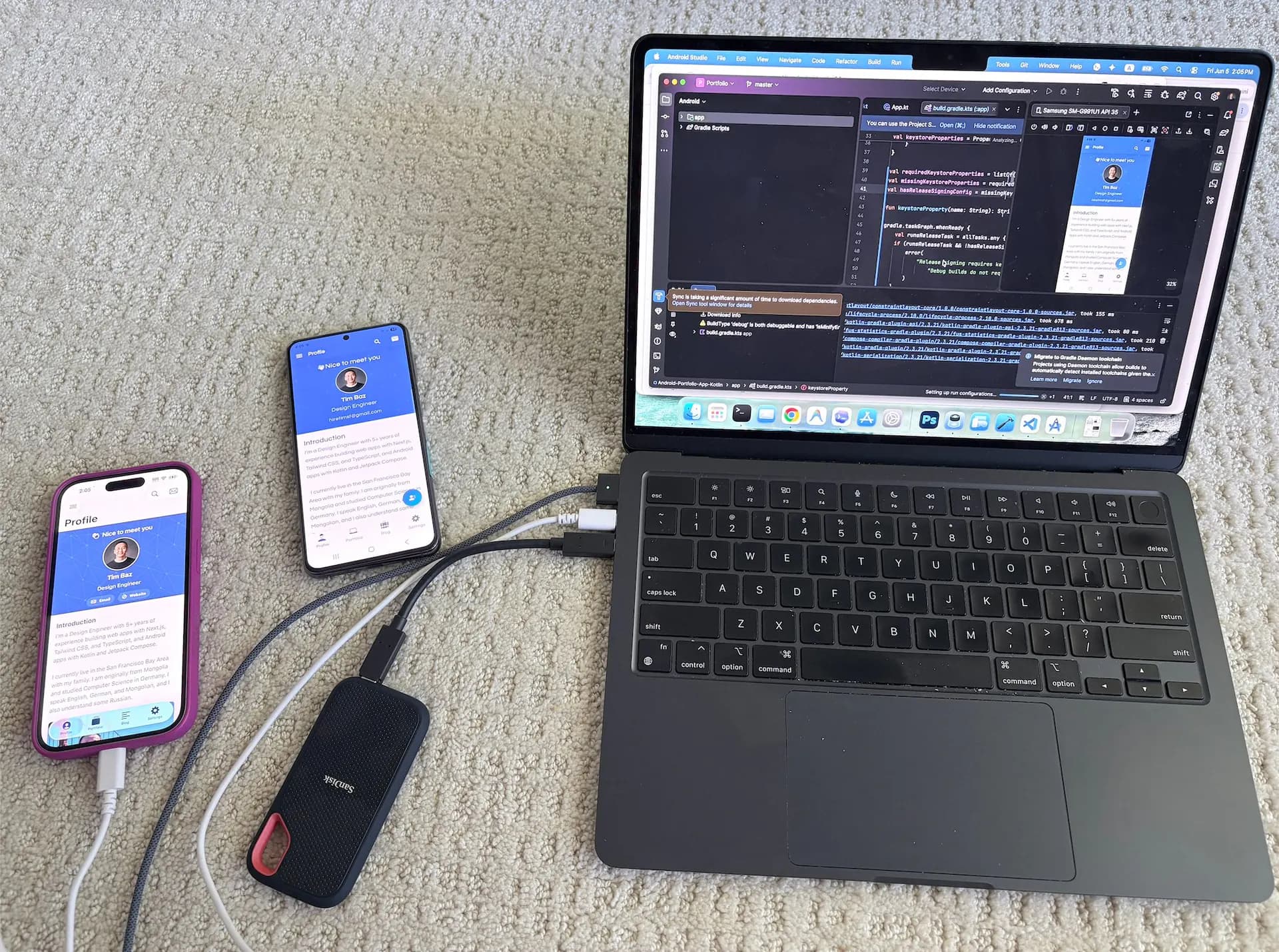 Portfolio app running across Android and iOS devices next to a laptop