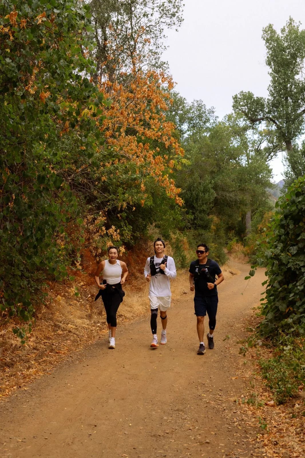 Three Iron Horse Run Club members climbing a shaded Mount Diablo trail together
