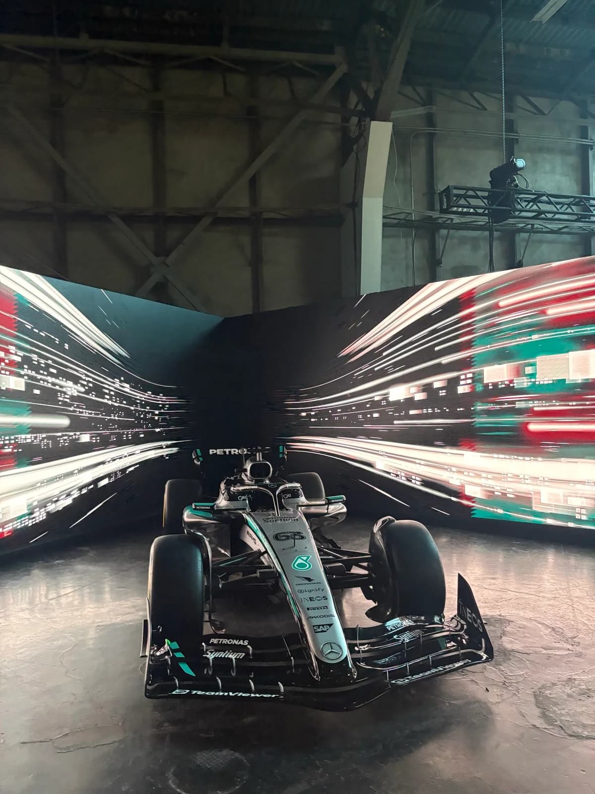 A Formula 1 car displayed against streaks of light at Vercel Ship SF