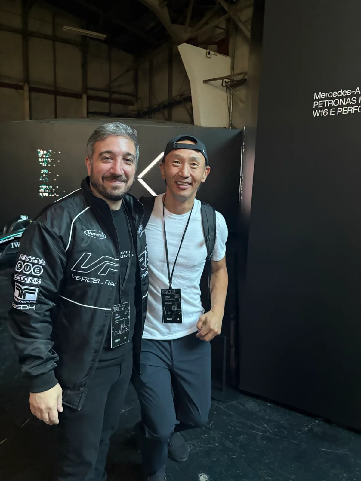 Tim with an attendee wearing a Vercel Racing Club jacket