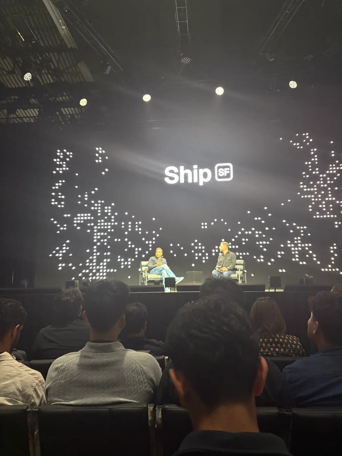 A stage conversation beneath the Ship SF logo and illuminated backdrop
