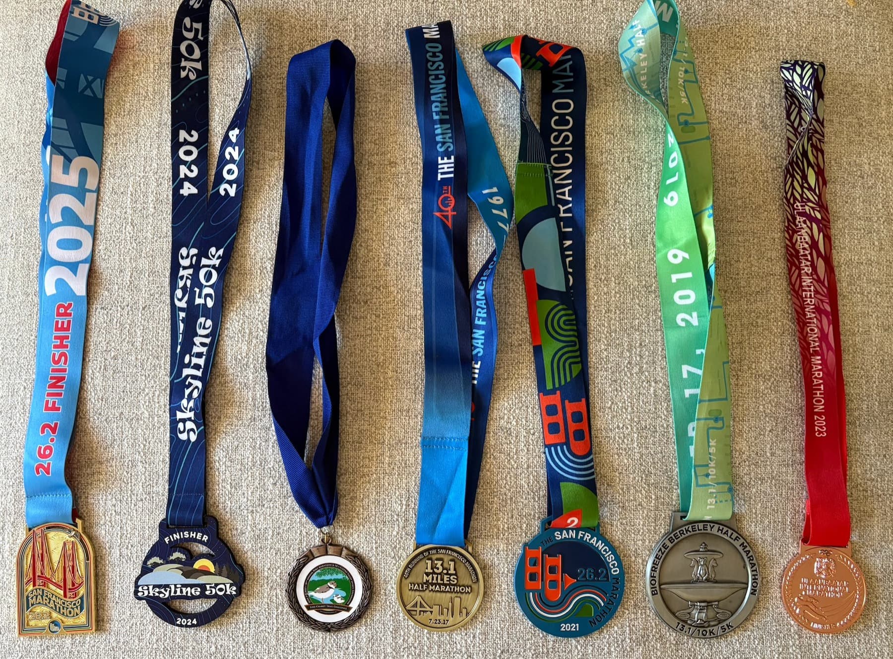 Running medals from marathons, half marathons, and trail
races