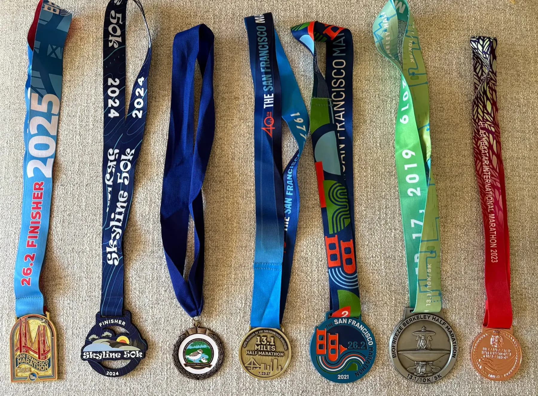 Running medals from marathons, half marathons, and trail
races